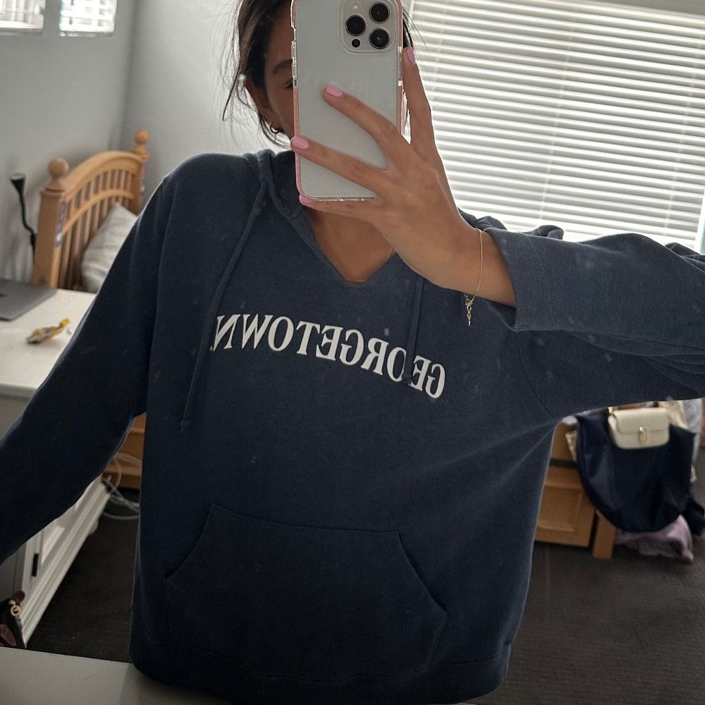 Light blue/grayish college hoodie with cutout